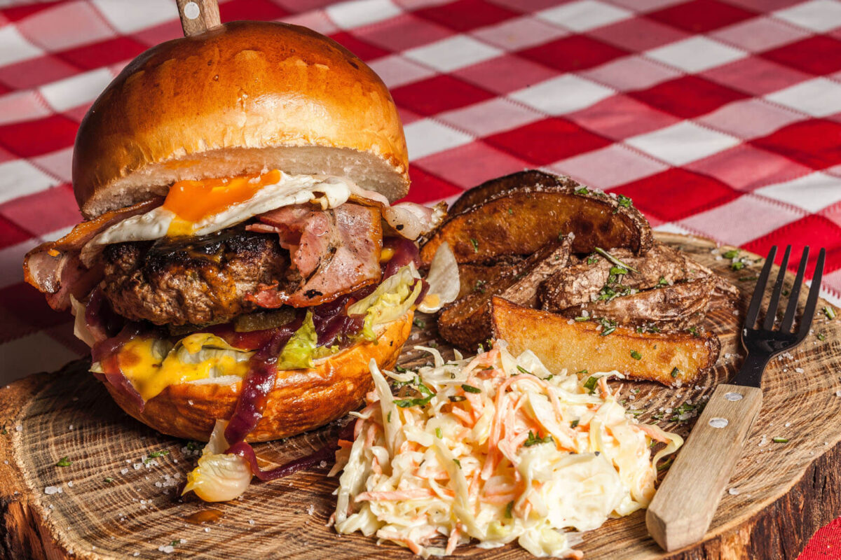 meat-burger-with-coleslaw-on-side-and-brown-handled-fork-156114.jpg